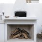 White outdoor fireplace with wood