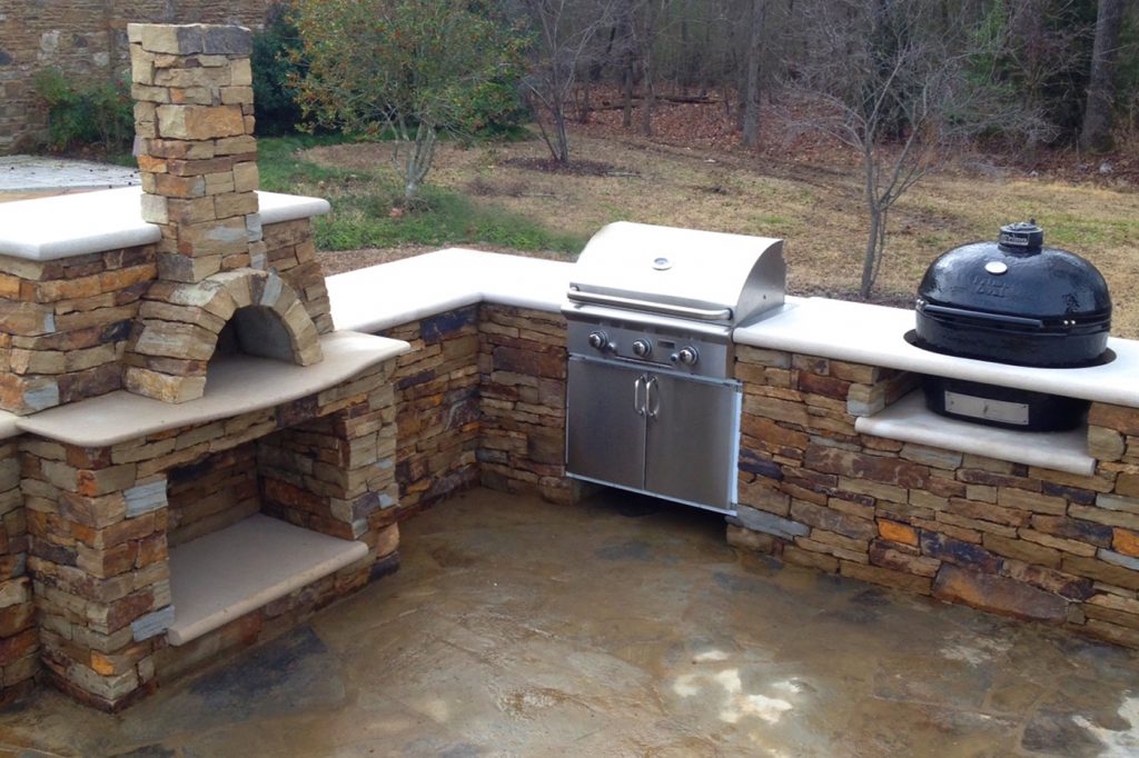 outdoor fireplace, pizza oven and outdoor grill area