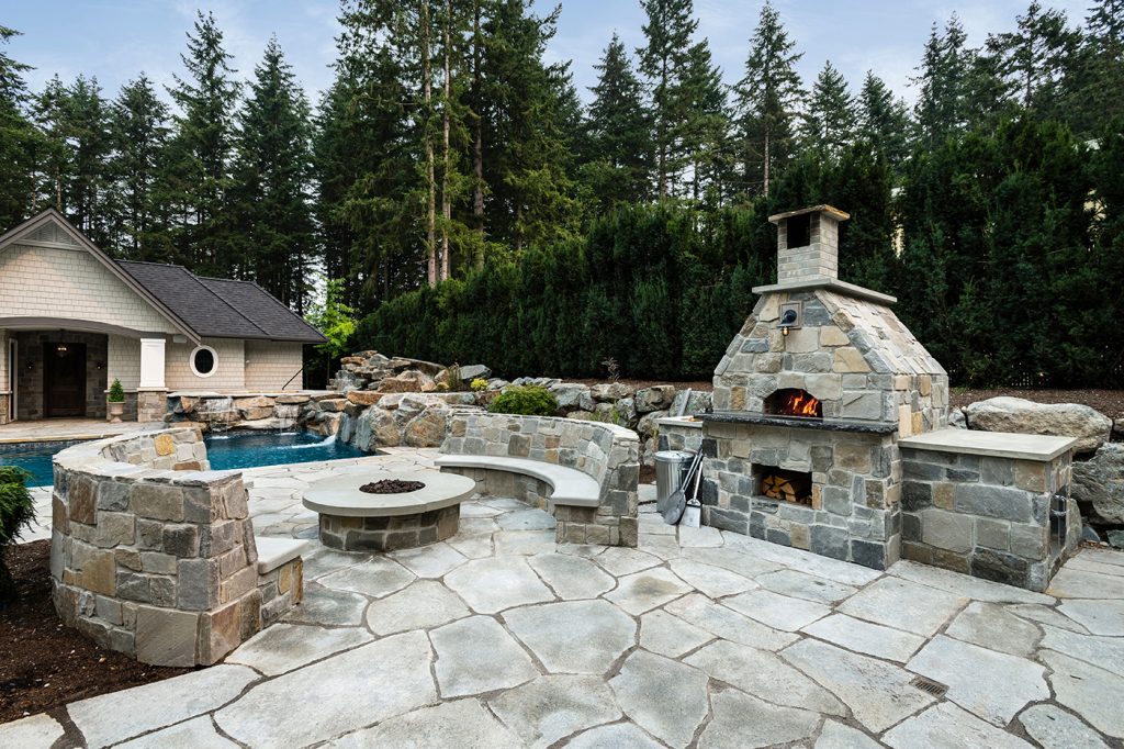 Outdoor space with firepit and fireplace plus pizza oven